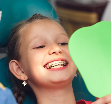 a girl with braces smiling