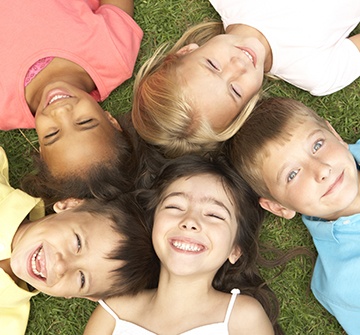 Group of kids smiling together outdoors