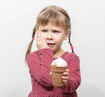 little girl in pain after eating ice cream
