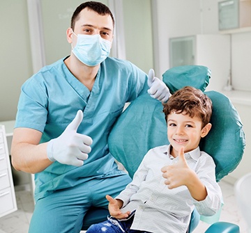 Pediatric dentist in Pelham smiling with child