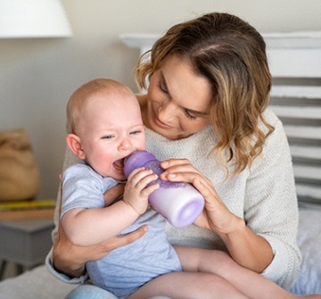 A mother trying to bottle feed experiencing difficulty because of need for laser frenectomy