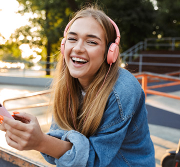 Patient smiling while listening to music with headphones
