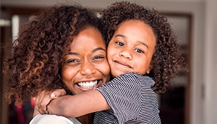 Mother and child smling together