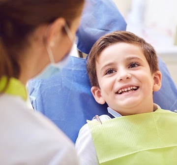 boy smiles at his dentist for children in Pelham during sports mouthguard visit