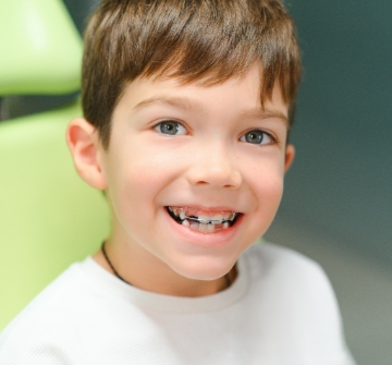 a child with braces smiling