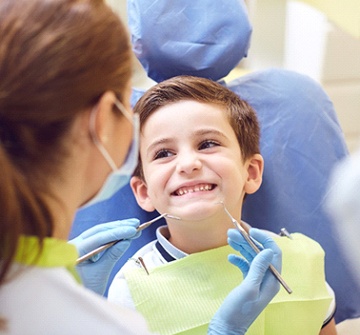A young boy in the dentist chair having his teeth checked for phase one orthodontic treatment