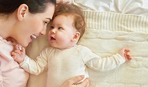 Mother and baby smiling after dentistry for infants visit