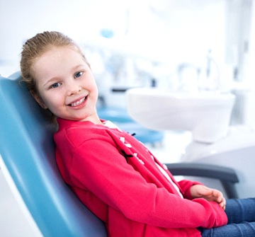 Smiling girl in dental chair during solea laser dentistry visit