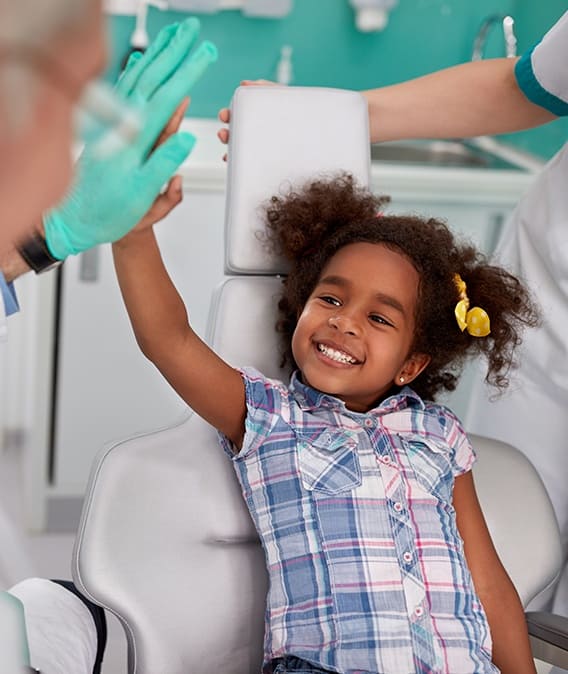 Little girl giving dentist high five