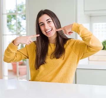 Teen girl smiling in kitchen at home