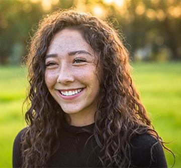 Teen smiling on field