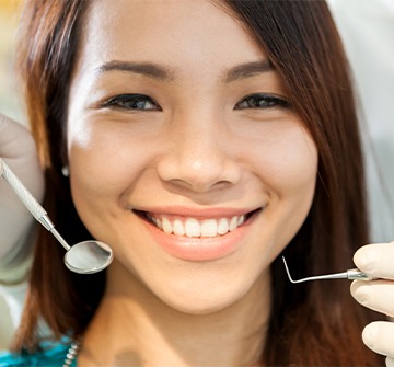 Teen girl receiving dental checkup