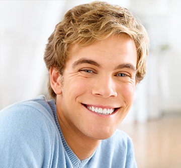 Young man with flawless smile after tooth-colored filling placement
