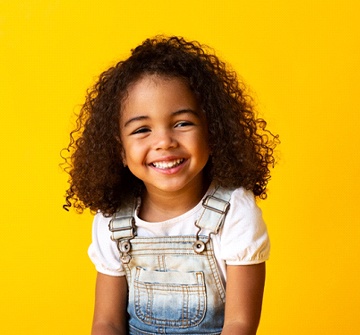 Girl smiles after visiting her Pelham pediatric dentist for thumb sucking