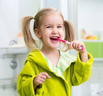 Toddler chewing on tooth brush