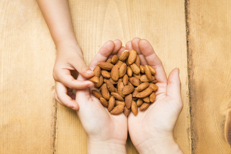 Child holding almonds