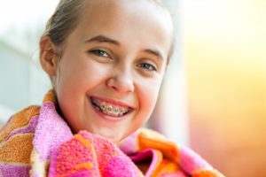 child with braces who just got done swimming