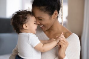 Mother playing with baby after laser frenectomy