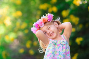 Smiling girl with flower crown enjoying Spring Break