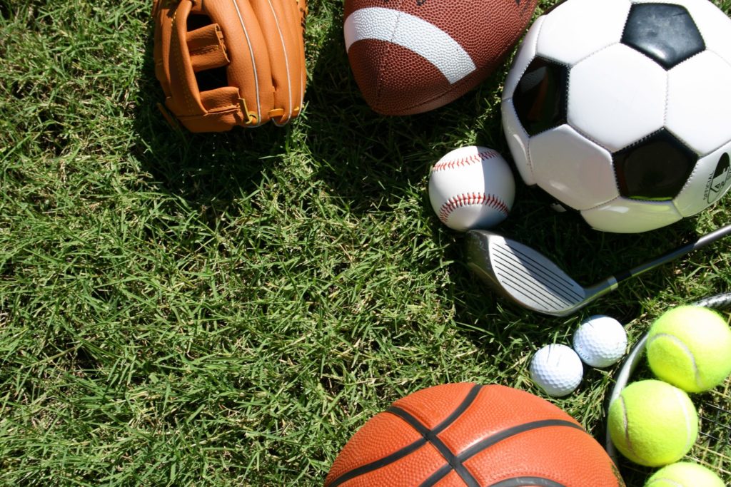 Assortment of sporting equipment on grass