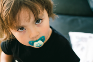 a child sucking on a pacifier