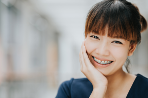 a patient with braces showing off their smile