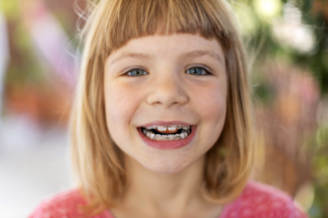 a child smiling while visiting the orthodontist